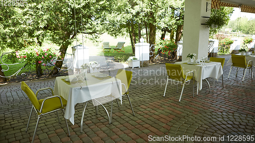 Image of terrace summer cafe with tables and chairs for people, an empty institution for recreation, nobody