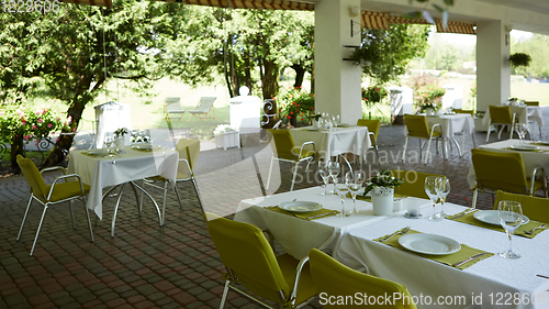 Image of terrace summer cafe with tables and chairs for people, an empty institution for recreation, nobody