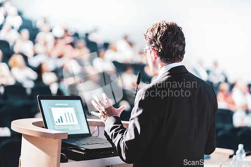 Image of Speaker at Business Conference with Public Presentations. Audience at the conference hall. Entrepreneurship club. Rear view. Horisontal composition. Background blur