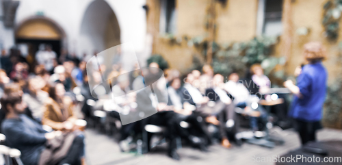 Image of Female speaker at Business Conference.