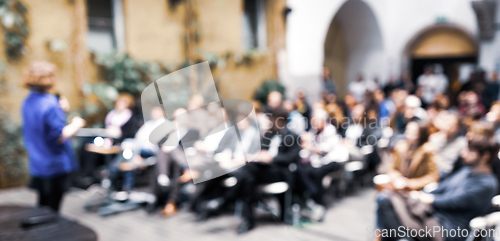 Image of Female speaker at Business Conference.