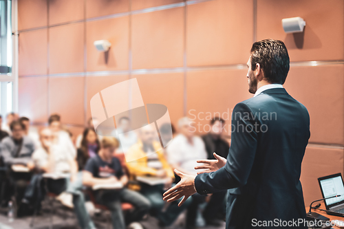 Image of Speaker at Business Conference with Public Presentations. Audience at the conference hall. Entrepreneurship club. Rear view. Horisontal composition. Background blur