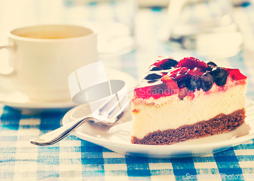 Image of Cake on plate with fork and coffee cup