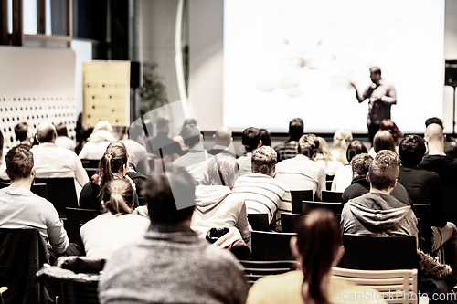 Image of Business speaker giving a talk at business conference event.