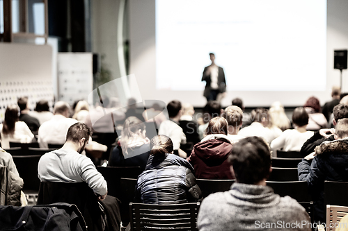 Image of Speaker at Business Conference with Public Presentations. Audience at the conference hall. Entrepreneurship club. Rear view. Horisontal composition. Background blur