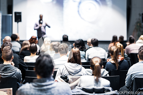 Image of Business speaker giving a talk at business conference event.