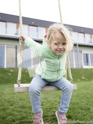 Image of Little girl on a swing