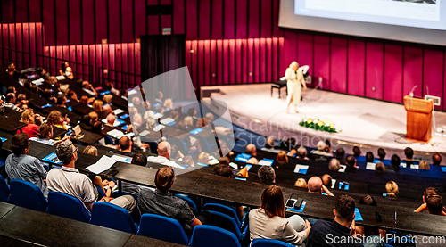 Image of Woman giving presentation on business conference event.