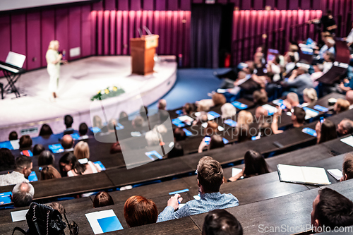 Image of Woman giving presentation on business conference event.