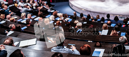 Image of Business and entrepreneurship symposium. Audience in conference hall. Rear view of unrecognized participant in audience.