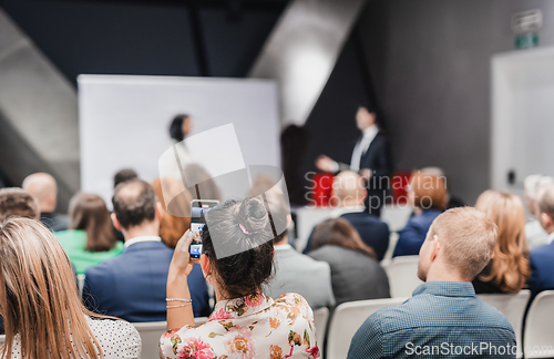 Image of Pitch presentation and project discussion at business convention or team meeting. Audience at the conference hall. Business and entrepreneurship symposium.