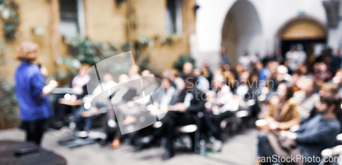 Image of Female speaker at Business Conference.