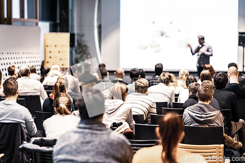 Image of Business speaker giving a talk at business conference event.