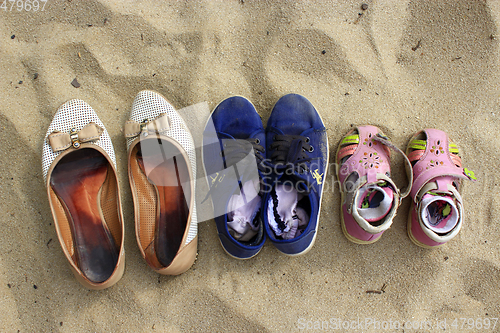 Image of footwear left by mother and her daughters