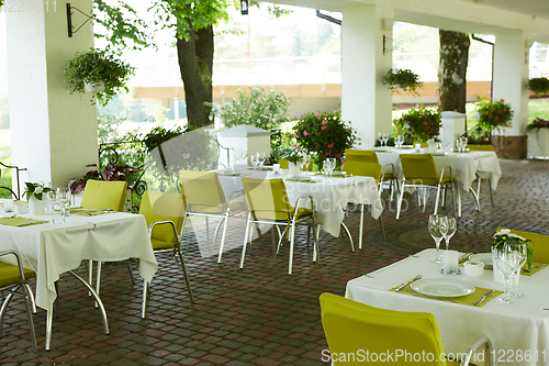 Image of terrace summer cafe with tables and chairs for people, an empty institution for recreation, nobody