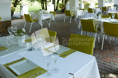 Image of terrace summer cafe with tables and chairs for people, an empty institution for recreation, nobody