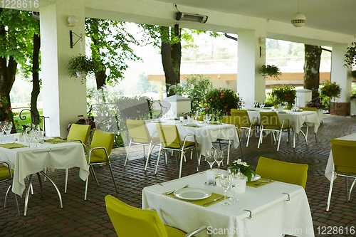 Image of terrace summer cafe with tables and chairs for people, an empty institution for recreation, nobody