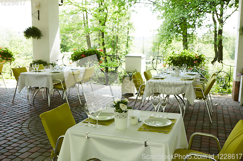 Image of terrace summer cafe with tables and chairs for people, an empty institution for recreation, nobody