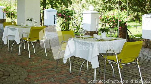 Image of terrace summer cafe with tables and chairs for people, an empty institution for recreation, nobody