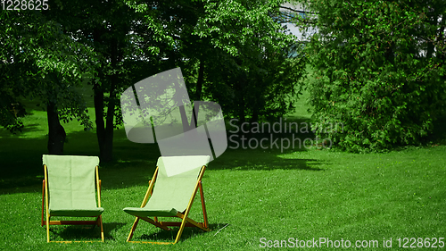 Image of Two resting chairs in the city park