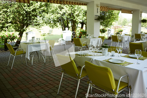 Image of terrace summer cafe with tables and chairs for people, an empty institution for recreation, nobody