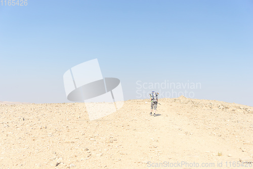 Image of Hiking tourist in desert trek adventure