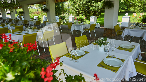 Image of terrace summer cafe with tables and chairs for people, an empty institution for recreation, nobody