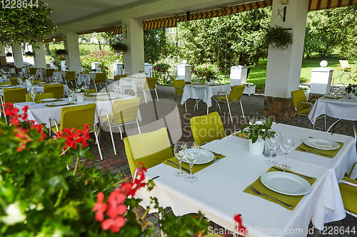 Image of terrace summer cafe with tables and chairs for people, an empty institution for recreation, nobody