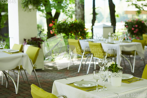 Image of terrace summer cafe with tables and chairs for people, an empty institution for recreation, nobody