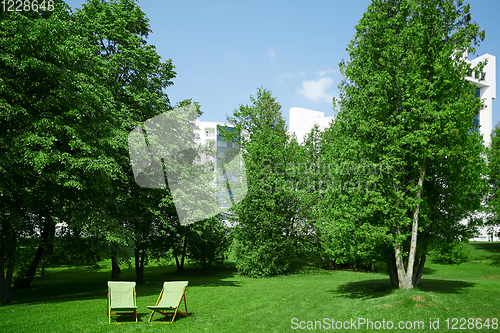 Image of Two resting chairs in the city park
