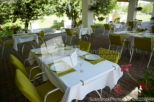 Image of terrace summer cafe with tables and chairs for people, an empty institution for recreation, nobody