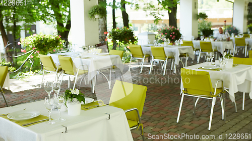 Image of terrace summer cafe with tables and chairs for people, an empty institution for recreation, nobody