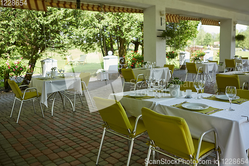 Image of terrace summer cafe with tables and chairs for people, an empty institution for recreation, nobody