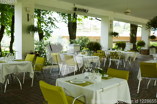 Image of terrace summer cafe with tables and chairs for people, an empty institution for recreation, nobody