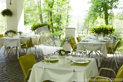 Image of terrace summer cafe with tables and chairs for people, an empty institution for recreation, nobody