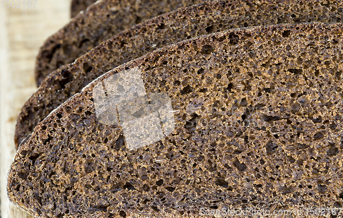 Image of black rye bread cut