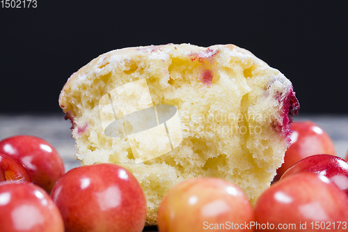 Image of Delicious muffin with baked cherry