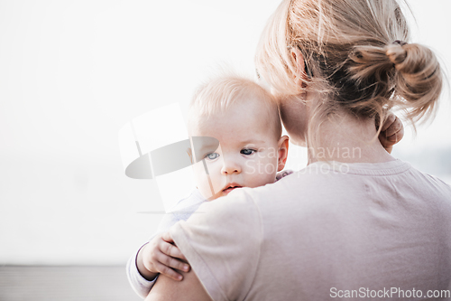 Image of Tender woman caressing her little baby boy infant child outdoors. Mother's unconditional love for her child