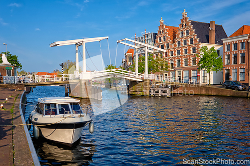 Image of Spaarne river with boat and Gravestenenbrug bridge in Haarlem, Netherlands