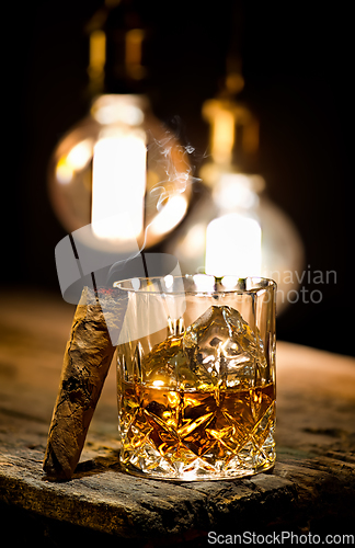 Image of Cigar and glass with whiskey