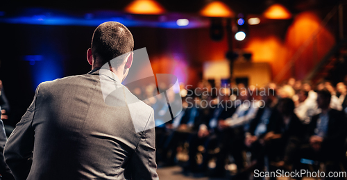 Image of Public speaker giving talk at Business Event.