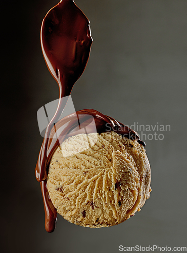 Image of melted chocolate pouring on ice cream ball