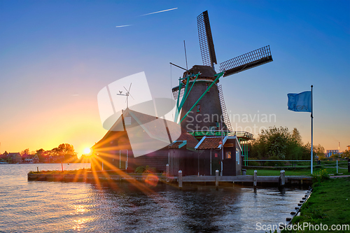 Image of Windmills at Zaanse Schans in Holland on sunset. Zaandam, Netherlands