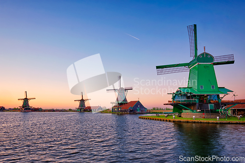 Image of Windmills at Zaanse Schans in Holland on sunset. Zaandam, Netherlands