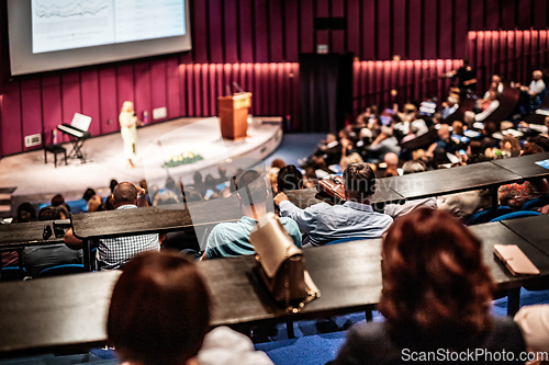 Image of Woman giving presentation on business conference event.