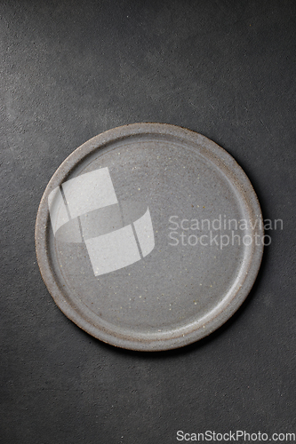 Image of empty plate on dark grey background