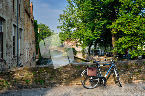 Image of Bicyccle on a bridge near canal and old houses. Bruges Brugge , Belgium