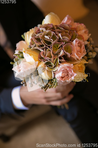 Image of Groom holding in hands delicate, expensive, trendy bridal wedding bouquet of flowers