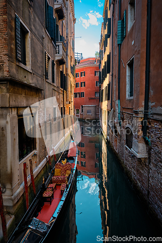 Image of Narrow canal with gondola in Venice, Italy