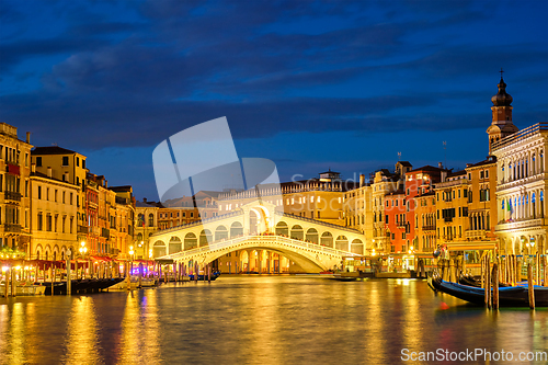 Image of Rialto bridge Ponte di Rialto over Grand Canal at night in Venice, Italy